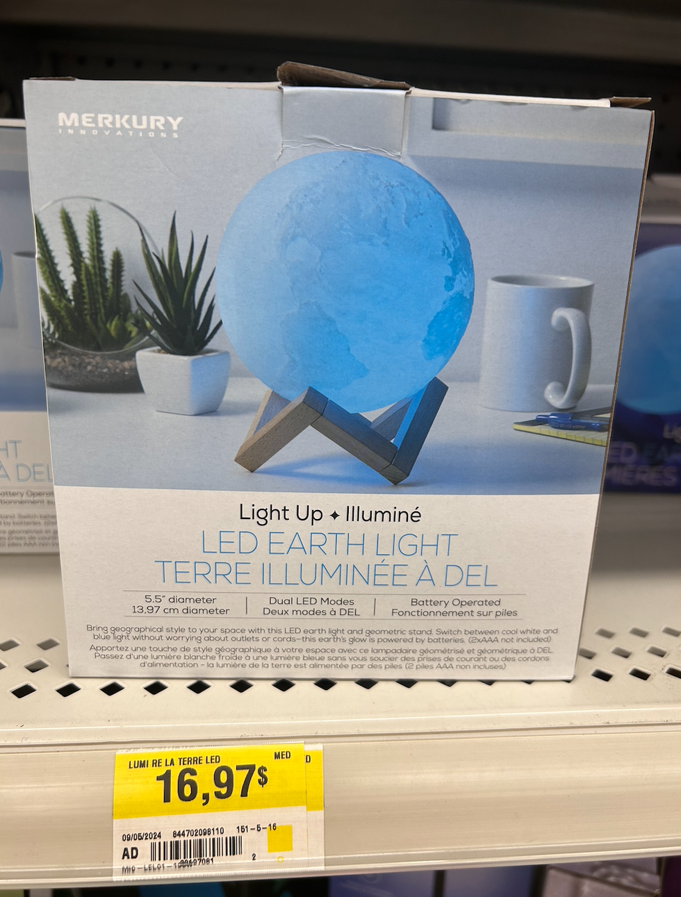 La boite d'une lampe en forme de Terre dans une \u00e9tag\u00e8re du Walmart.
