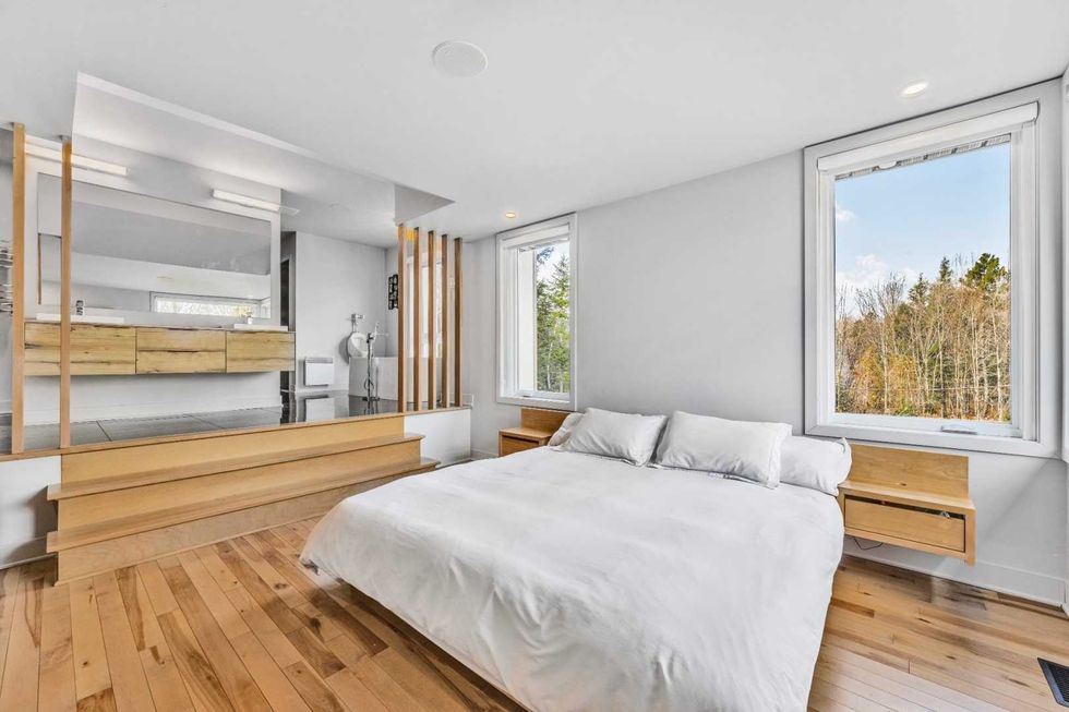 La chambre principale avec la salle de bain \u00e0 aire ouverte.