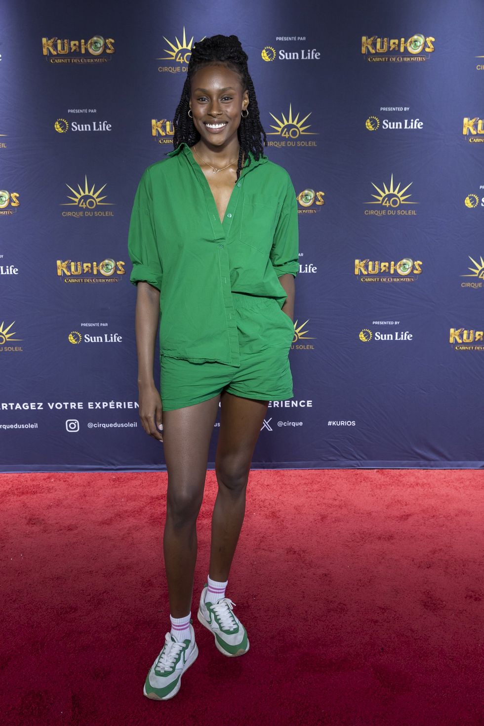 Na\u00efla Louidort, tout en vert, sur le tapis rouge de Kurios du Cirque du Soleil.