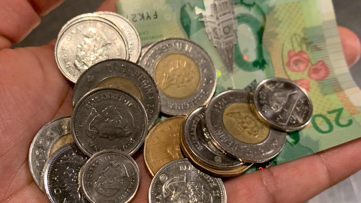 Person holding Canadian money.