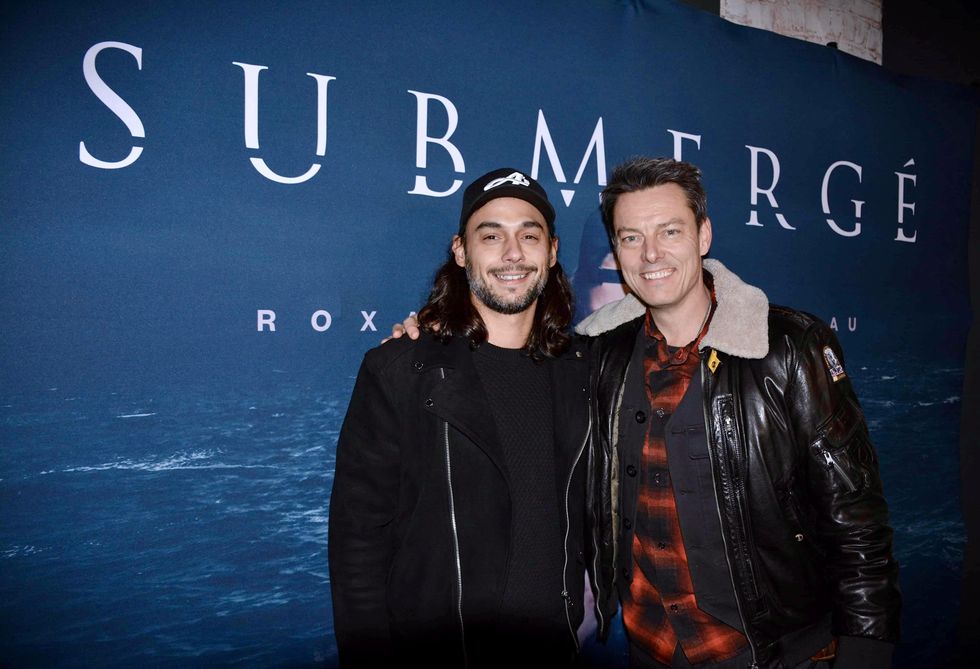 Pierre-Paul Alain et Jean-Fran\u00e7ois Beaupr\u00e9 qui posent devant l'affiche de Submerg\u00e9.