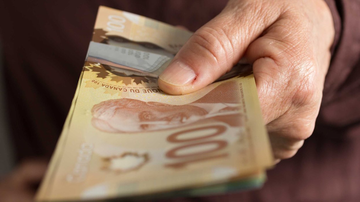 Someone holding Canadian money.