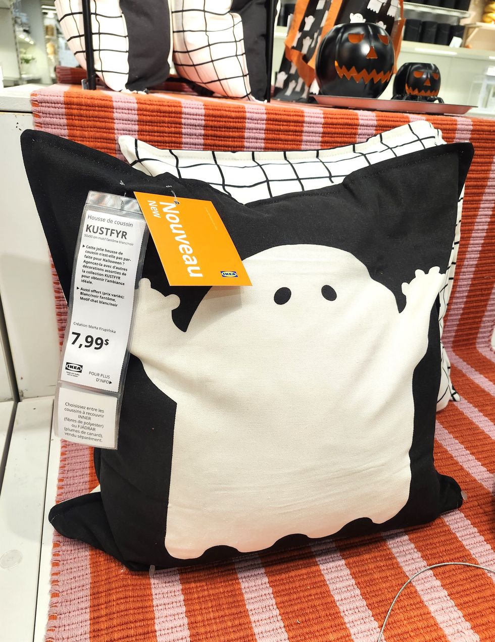 Un coussin noir avec un fant\u00f4me blanc.