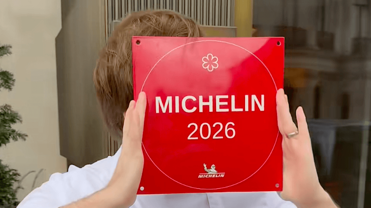 Une personne qui tient une affiche avec une étoile Michelin.