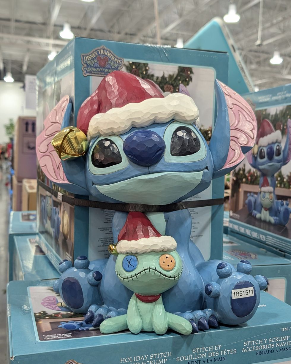 Une statue d\u00e9corative des personnages de Disney Stitch et Souillon qui portent des tuques de No\u00ebl vendue dans le rayon des articles saisonniers chez Costco.